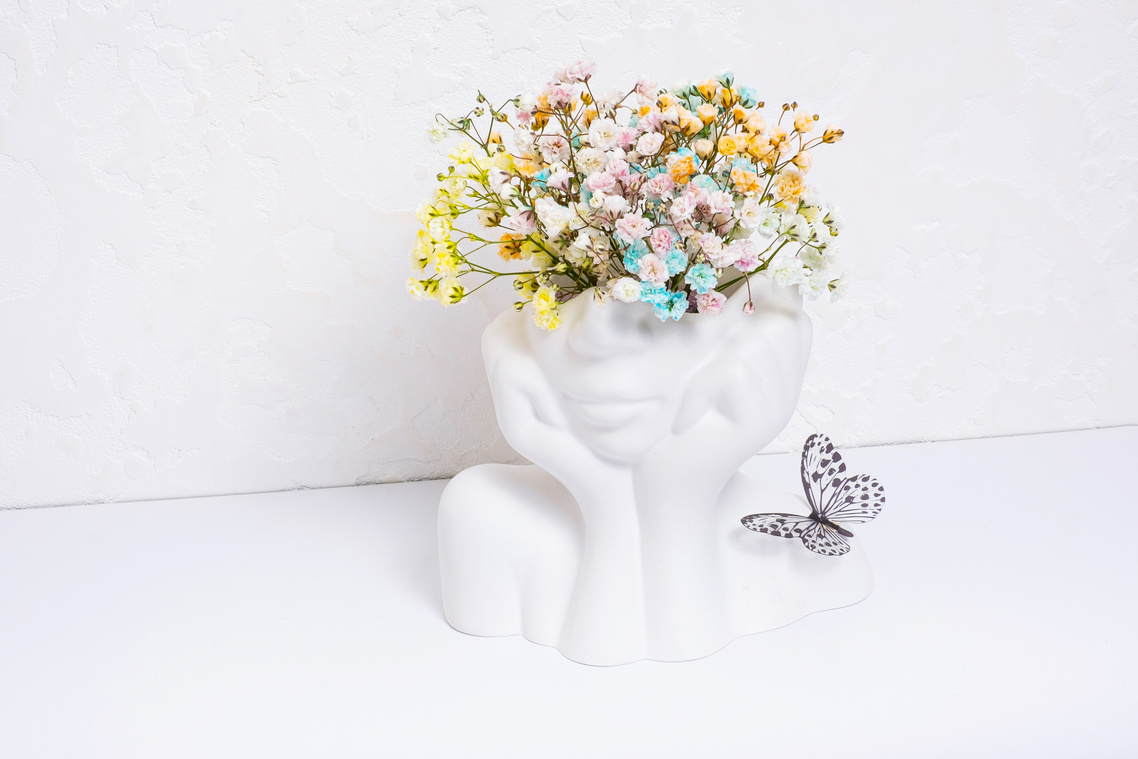Mental health concept. Creative plaster vase head-shape with col